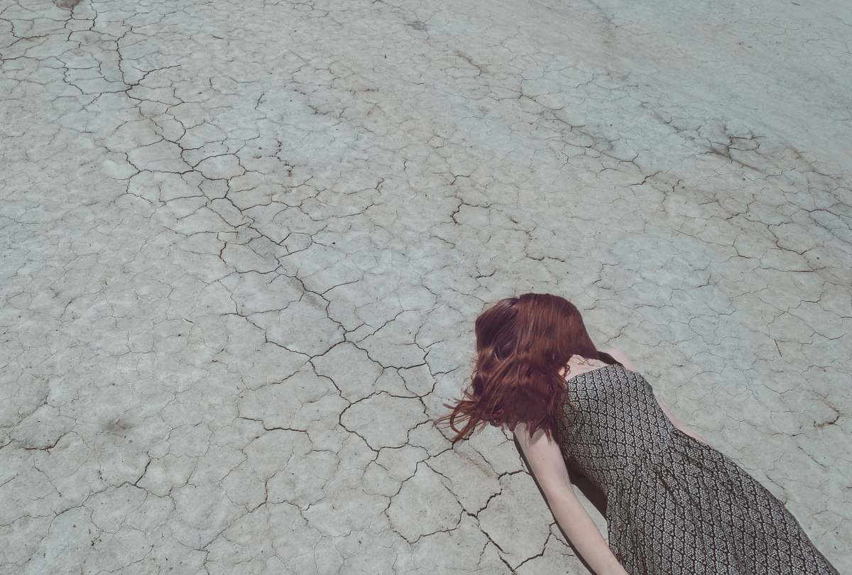 new zealand woman lying on ground dry